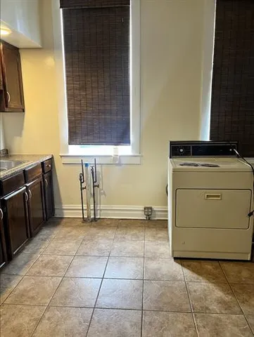 a kitchen with a stove top oven and cabinets