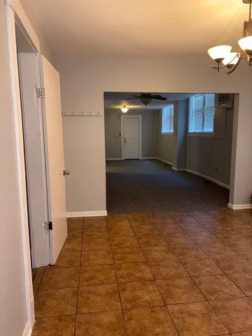 an empty room with windows and entrance