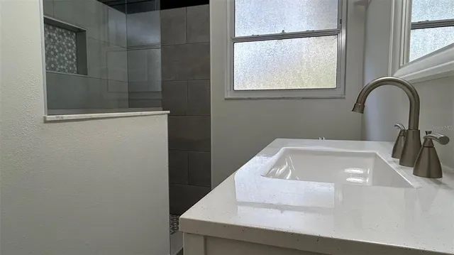 a bathroom with a sink and a window