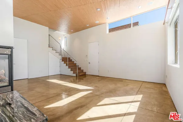 a kitchen with stainless steel appliances granite countertop a refrigerator a stove and a sink