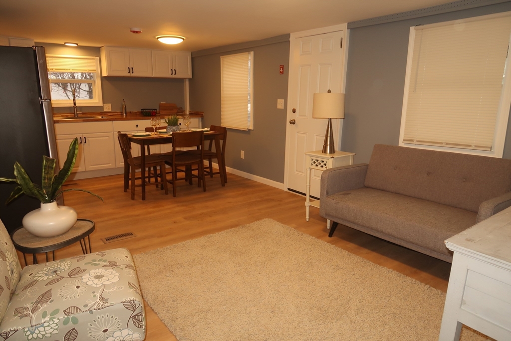 229 Miller Street, Unit 3G Ludlow, MA 01056 - Photo 4 of 15 a living room with furniture and a dining table with kitchen view