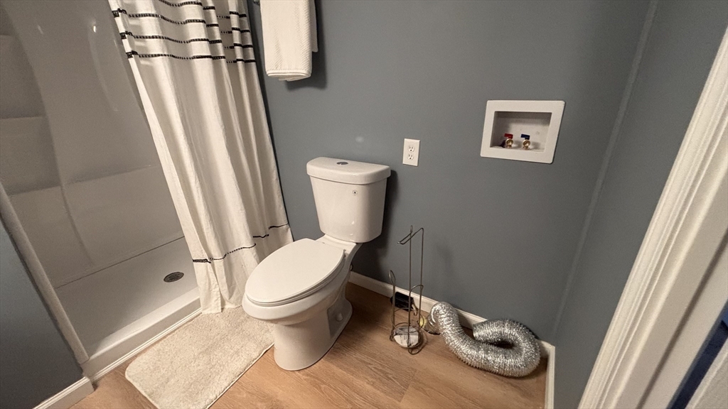 229 Miller Street, Unit 3G Ludlow, MA 01056 - Photo 10 of 15 a white toilet sitting next to a small yard