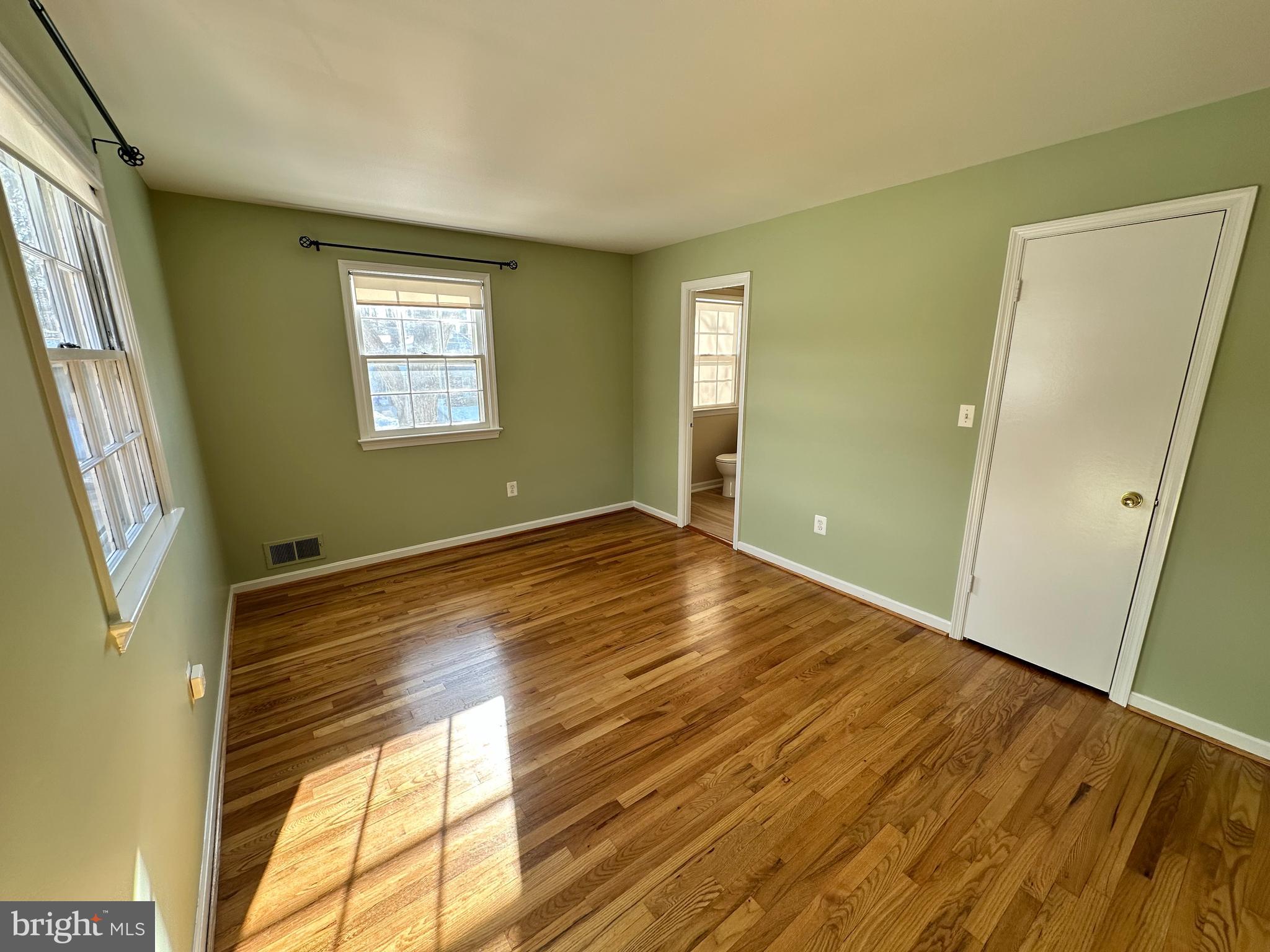 4405 Bel Pre Road Rockville, MD 20853 - Photo 11 of 24 a view of empty room with wooden floor and fan