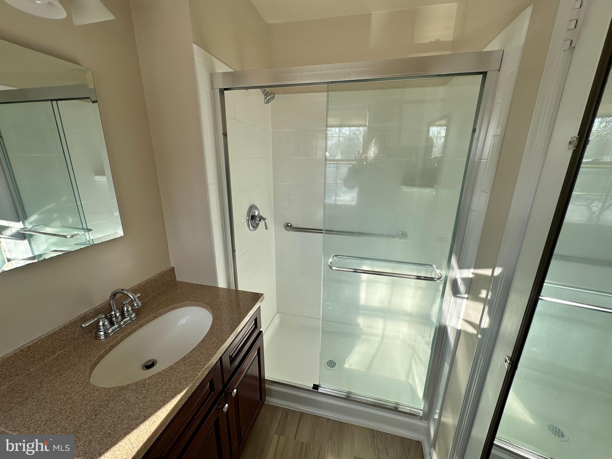 4405 Bel Pre Road Rockville, MD 20853 - Photo 14 of 24 a bathroom with a sink vanity granite tub shower and mirror