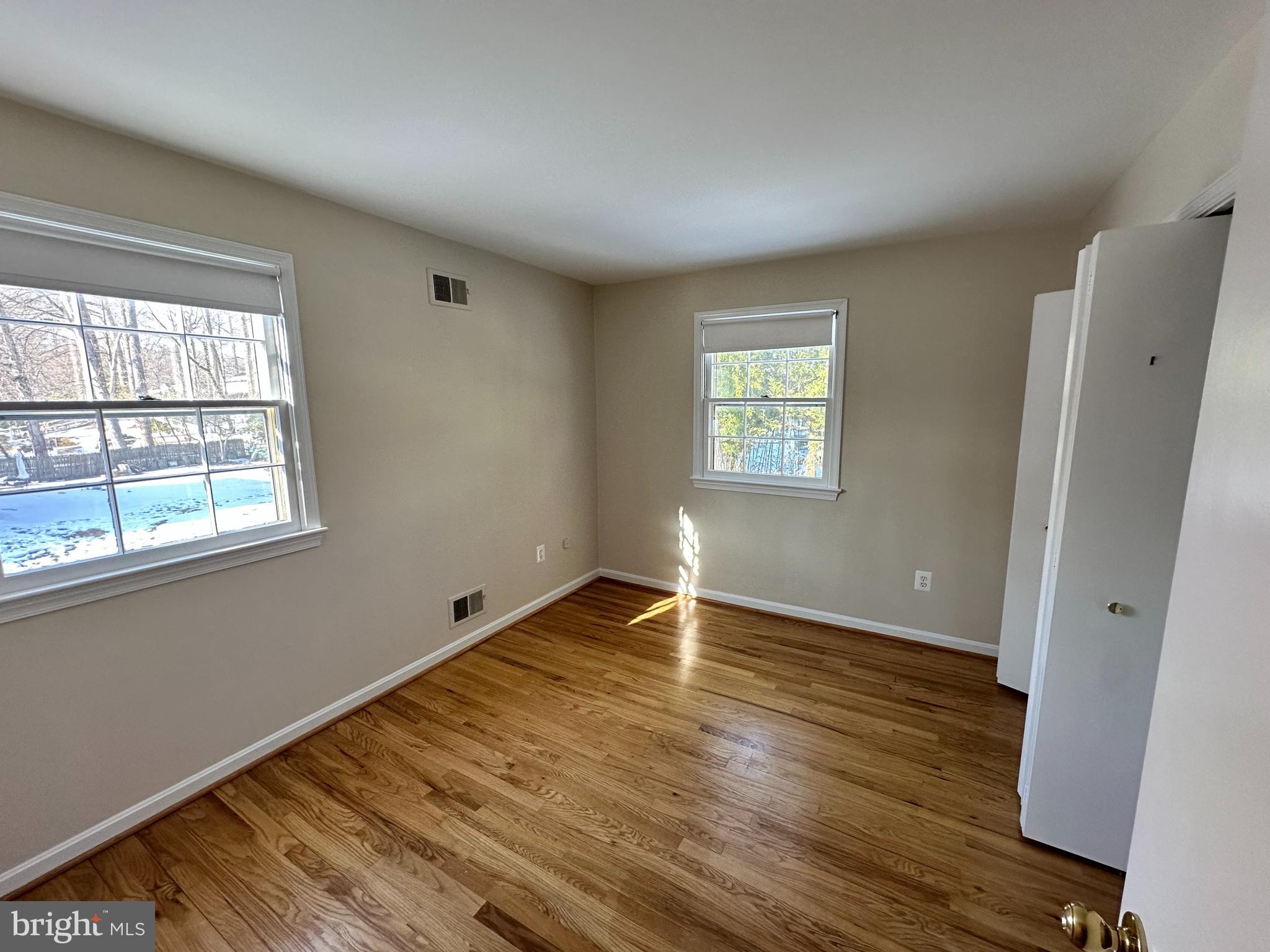 4405 Bel Pre Road Rockville, MD 20853 - Photo 15 of 24 a view of an empty room with wooden floor and a window