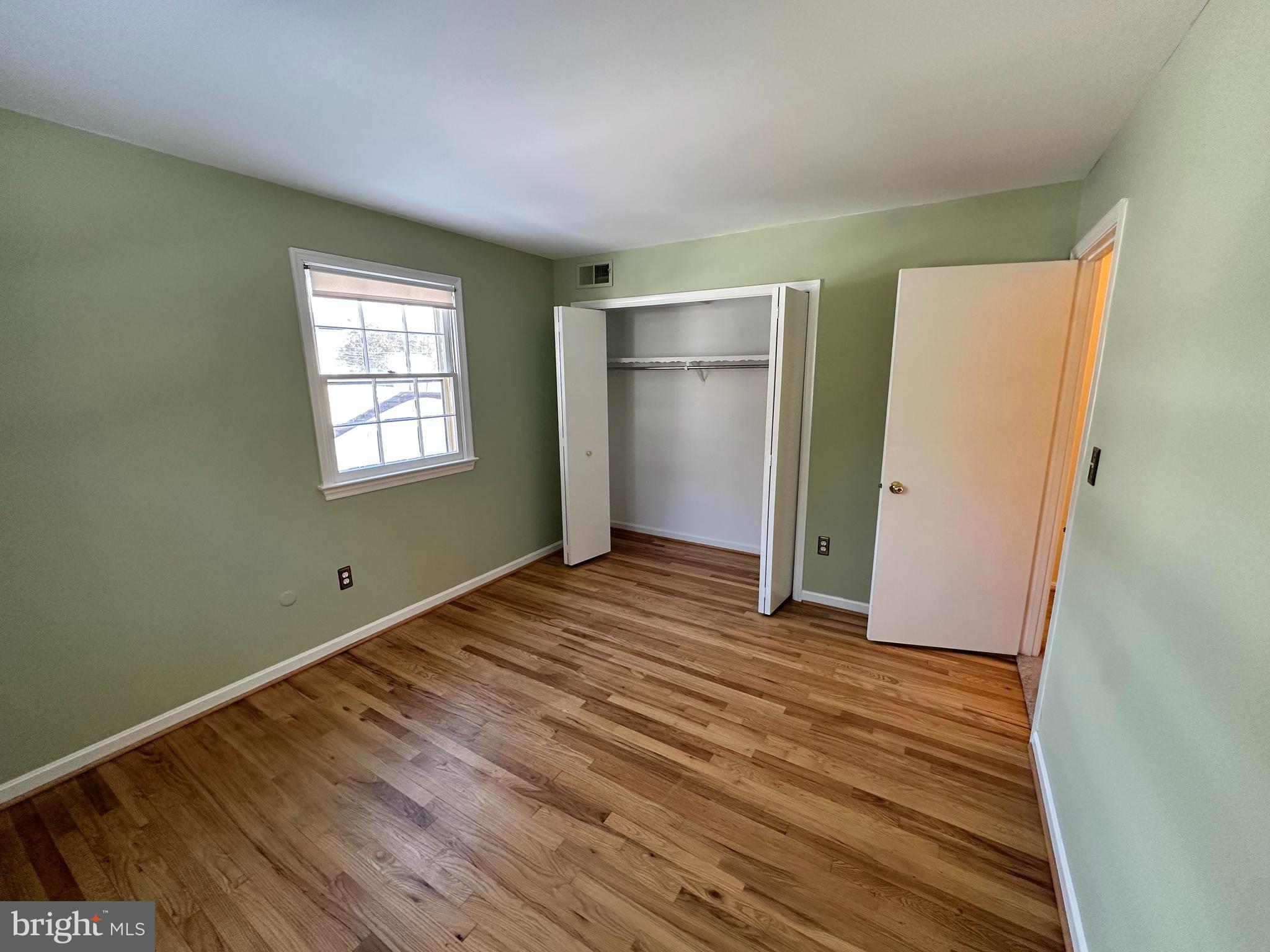 4405 Bel Pre Road Rockville, MD 20853 - Photo 18 of 24 a view of an empty room with wooden floor and a window