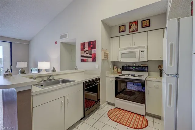 a kitchen with stainless steel appliances a stove a sink and a refrigerator