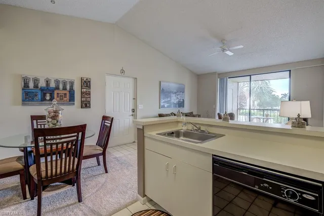 a kitchen that has a sink a stove counter top space and a window in it