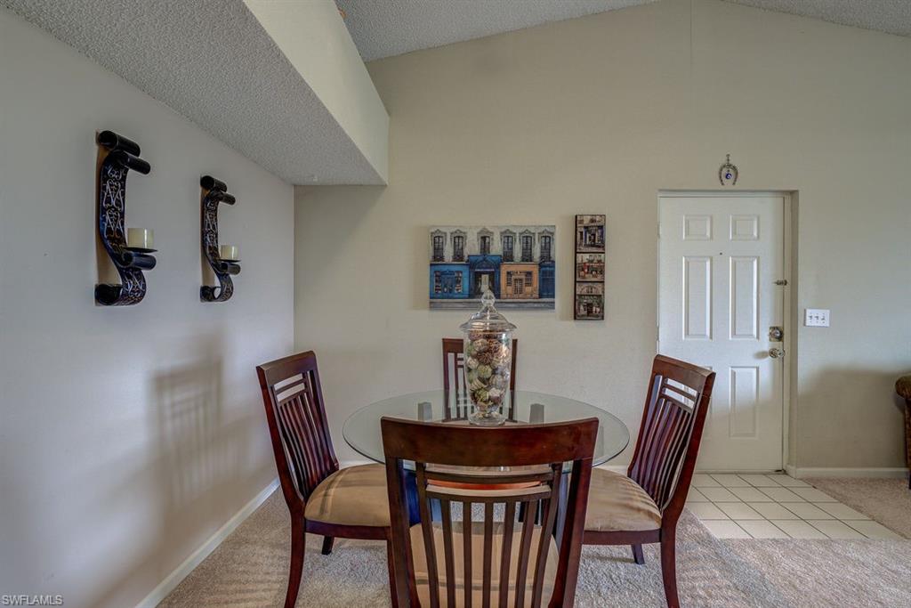 13545 Eagle Ridge Drive, Unit 827 Fort Myers, FL 33912 - Photo 19 of 27 a view of a dining room with furniture and wooden floor
