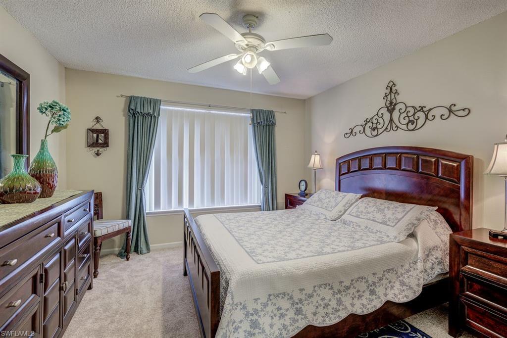 13545 Eagle Ridge Drive, Unit 827 Fort Myers, FL 33912 - Photo 22 of 27 a bed sitting in a bedroom next to a window