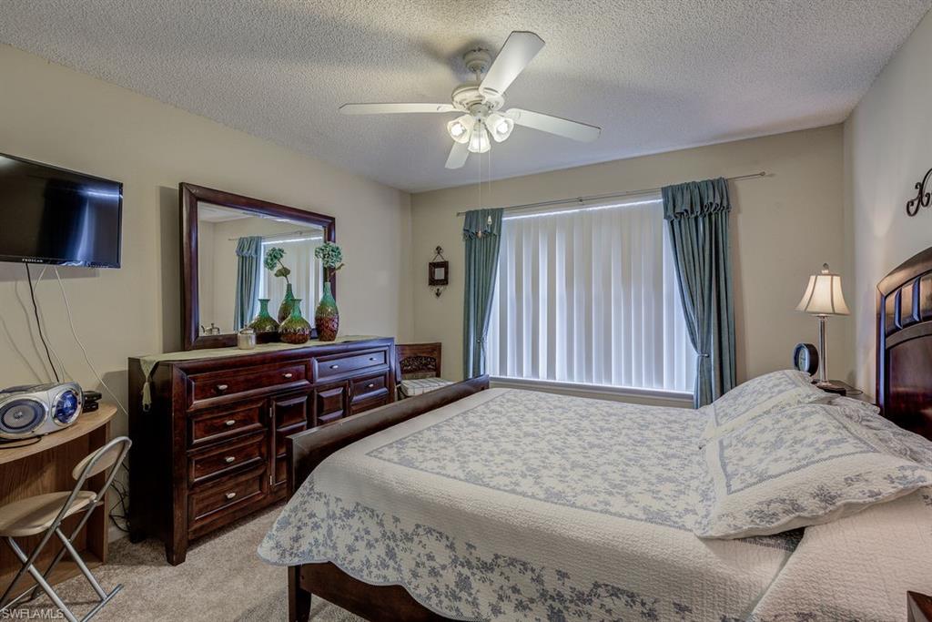 13545 Eagle Ridge Drive, Unit 827 Fort Myers, FL 33912 - Photo 23 of 27 a bedroom with a bed and a dresser