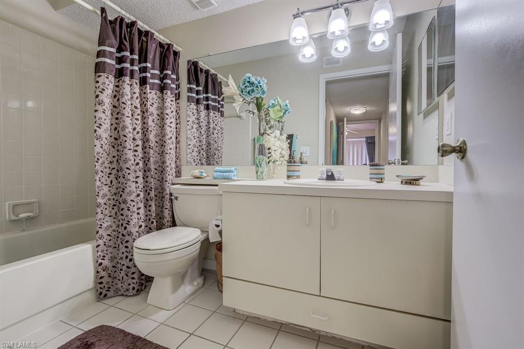 13545 Eagle Ridge Drive, Unit 827 Fort Myers, FL 33912 - Photo 24 of 27 a bathroom with a sink toilet and shower