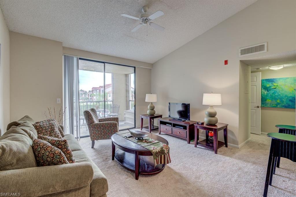 13545 Eagle Ridge Drive, Unit 827 Fort Myers, FL 33912 - Photo 7 of 27 a living room with furniture and a large window