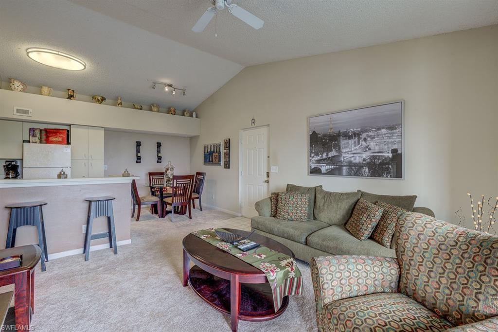 13545 Eagle Ridge Drive, Unit 827 Fort Myers, FL 33912 - Photo 9 of 27 a living room with furniture and a table