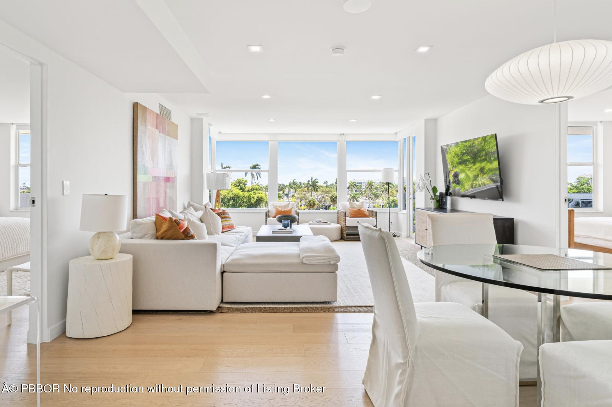 a living room with fireplace furniture and a large window