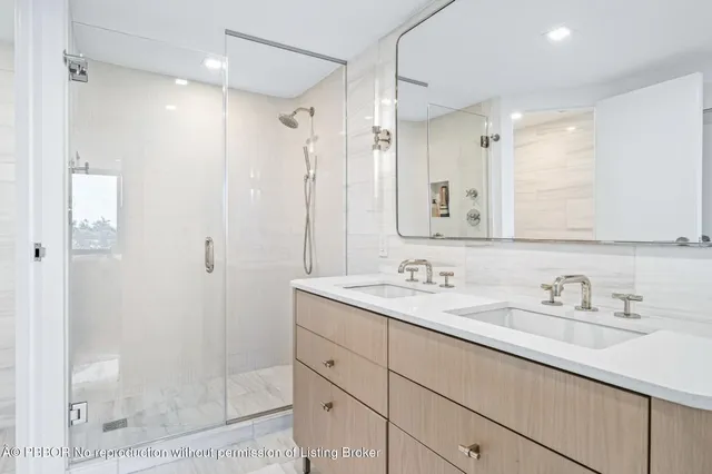 a bathroom with a shower sink and mirror