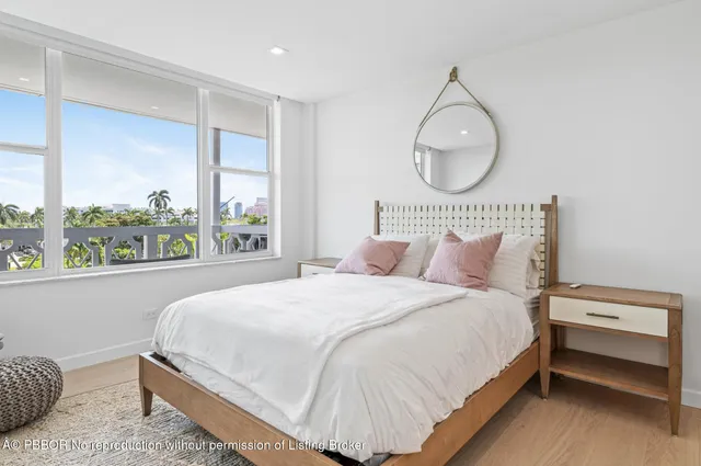 a bedroom with a bed a window and dresser