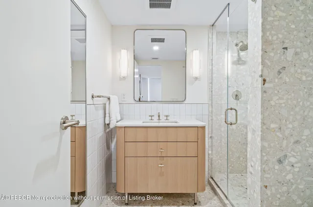 a bathroom with a sink and mirror