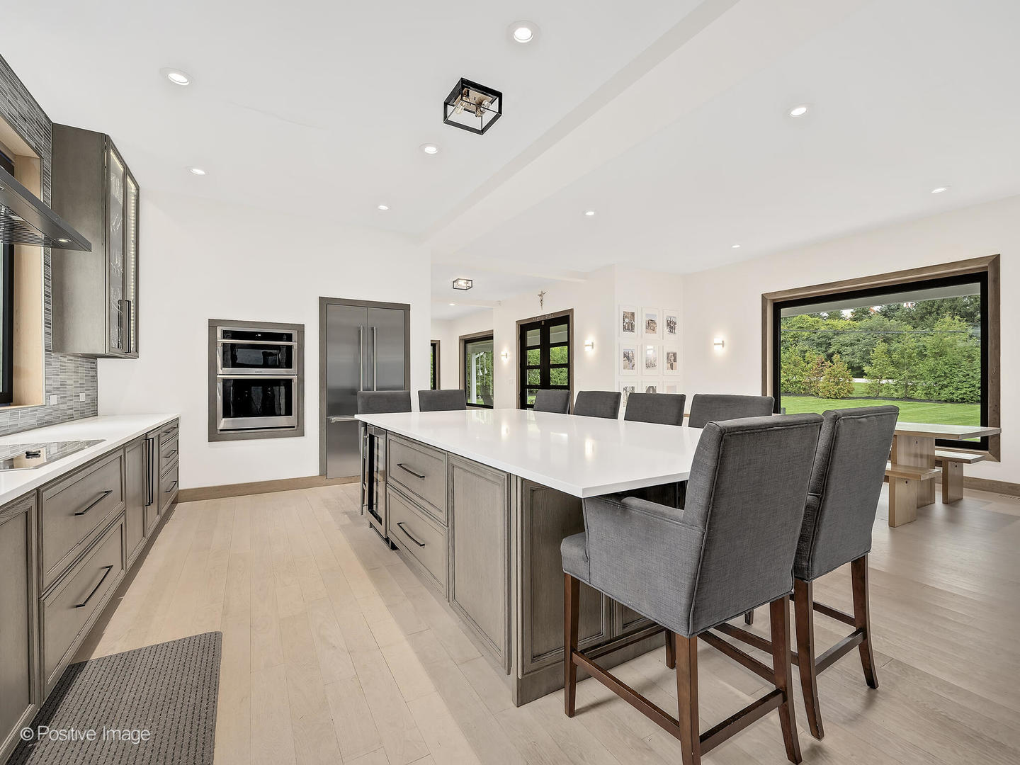 11670 79th Street Burr Ridge, IL 60527 - Photo 8 of 31 a large kitchen with stainless steel appliances granite countertop a stove a sink a dining table and chairs