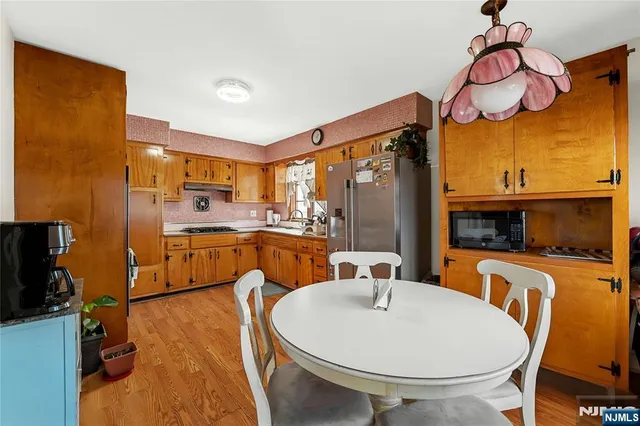 a bedroom with a bed and dresser with chair