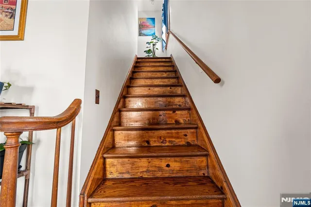 a view of a livingroom with furniture and staircase