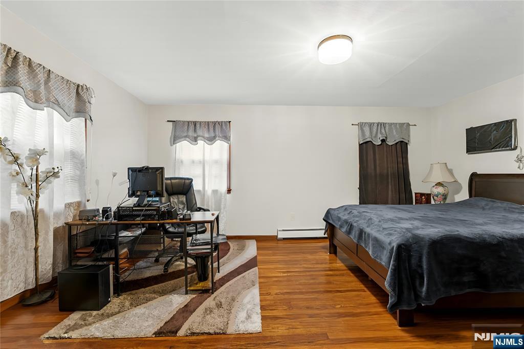 29 Harding Avenue North Arlington, NJ 07031 - Photo 25 of 44 a bedroom with a bed and a flat screen tv