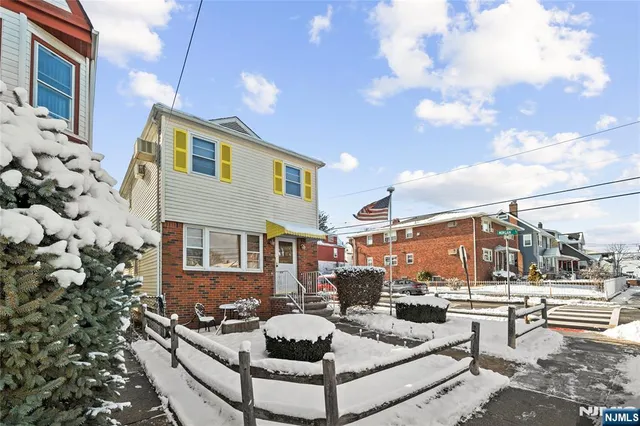 a front view of a house with outdoor seating