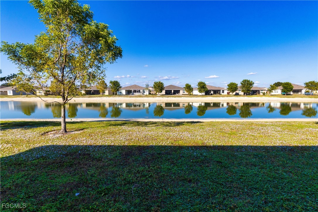 10749 Crossback Lane Lehigh Acres, FL 33974 - Photo 14 of 21 a view of a big yard with an outdoor space and seating area