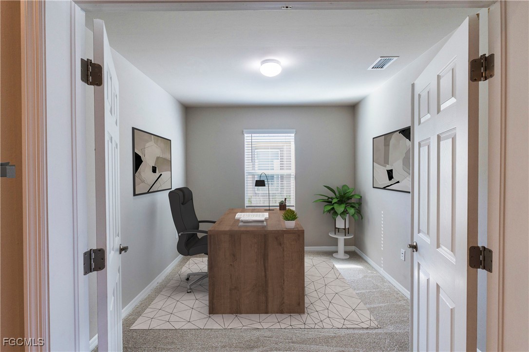 10749 Crossback Lane Lehigh Acres, FL 33974 - Photo 4 of 21 a view of a hallway with dining area and glass door