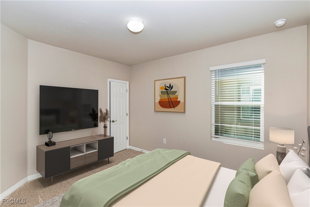 10749 Crossback Lane Lehigh Acres, FL 33974 - Photo 6 of 21 a bedroom with a bed and a flat screen tv