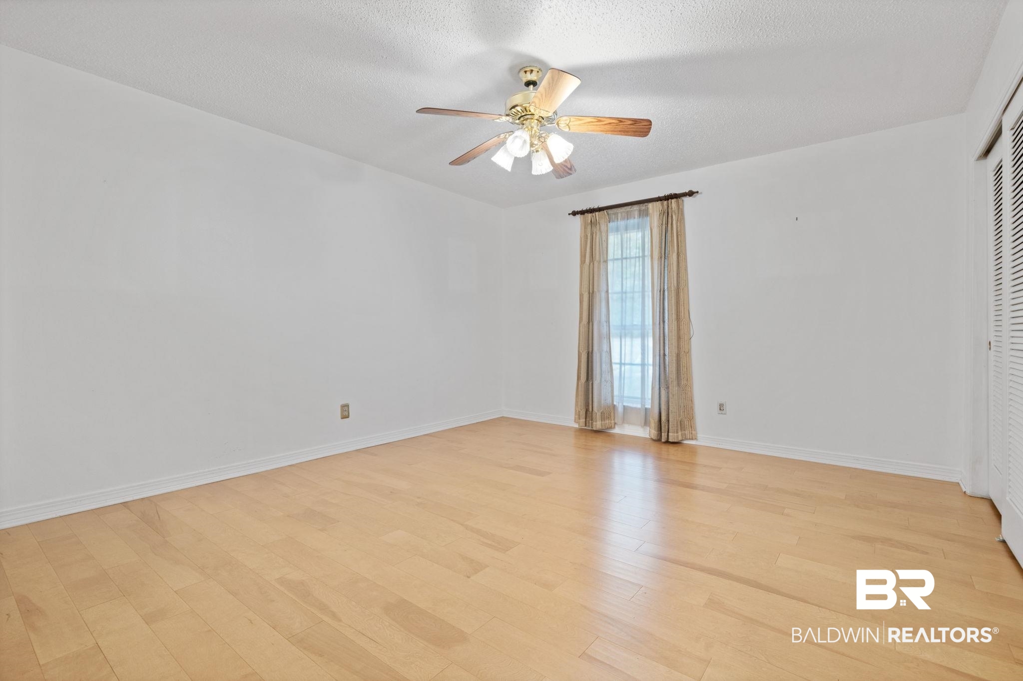 6261 Old Pascagoula Road Theodore, AL 36582 - Photo 22 of 29 Unfurnished room with a textured ceiling, ceiling fan, and light wood-type flooring