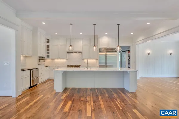 a open kitchen with kitchen island white cabinets and counter space