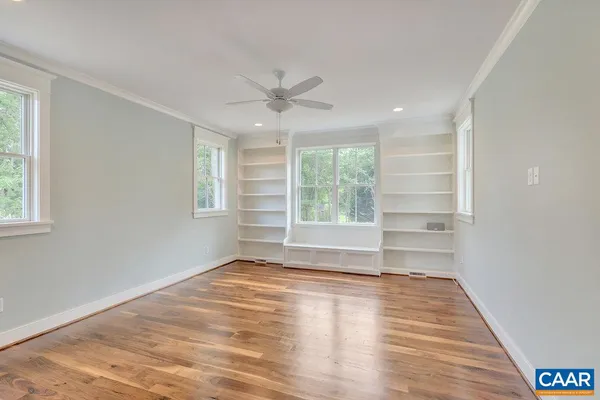 a view of wooden floor and windows in a room