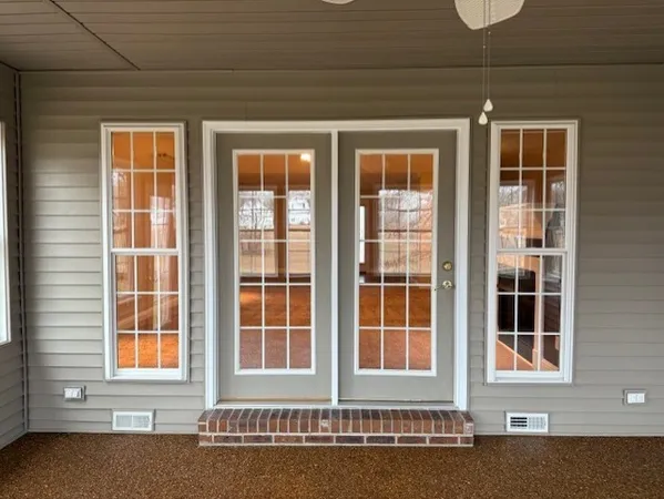 a view of a brick house with many windows