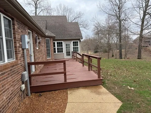 a view of a house with a wooden fence