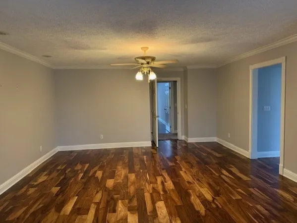 a view of an empty room and wooden floor