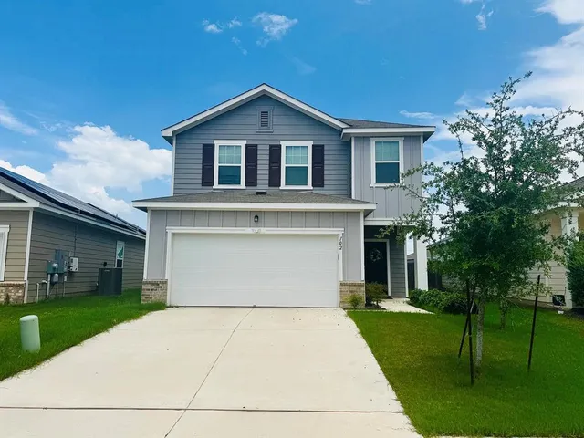 a front view of house with yard and green space