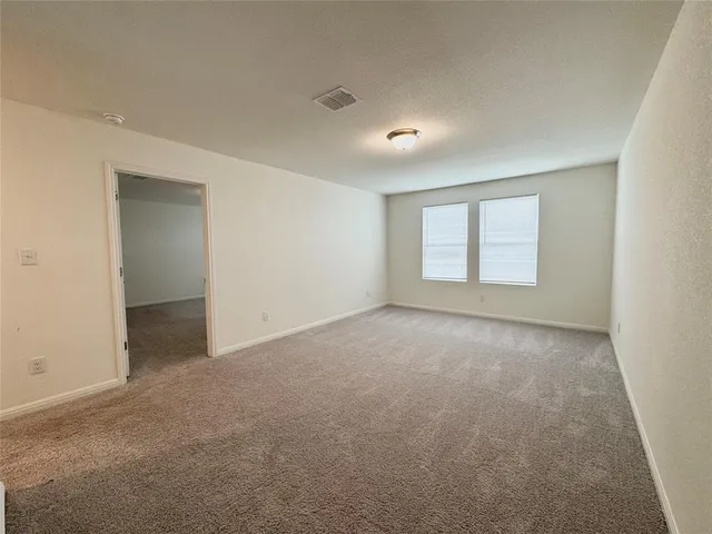 an empty room with a empty space and windows