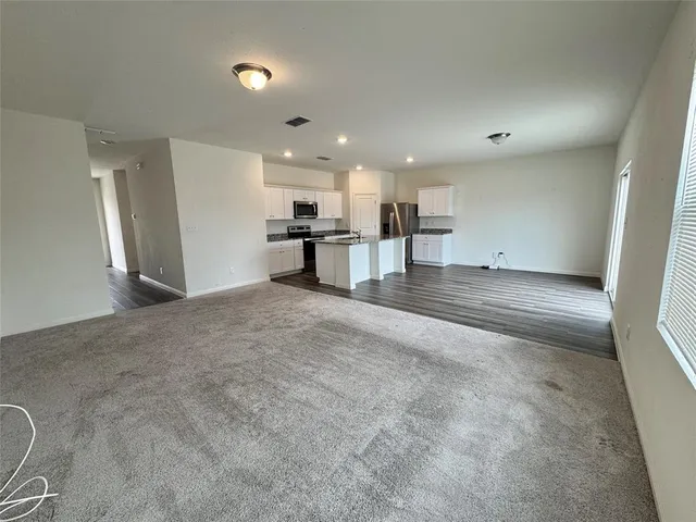 a view of a kitchen with a sink and cabinets