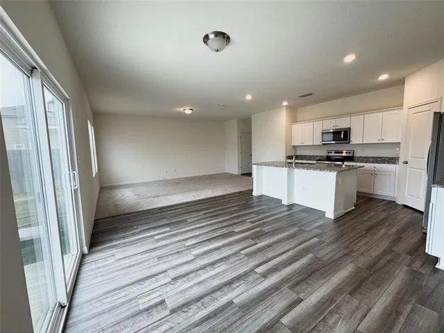 a view of a backyard with wooden fence