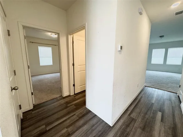 a view of kitchen with sink and refrigerator