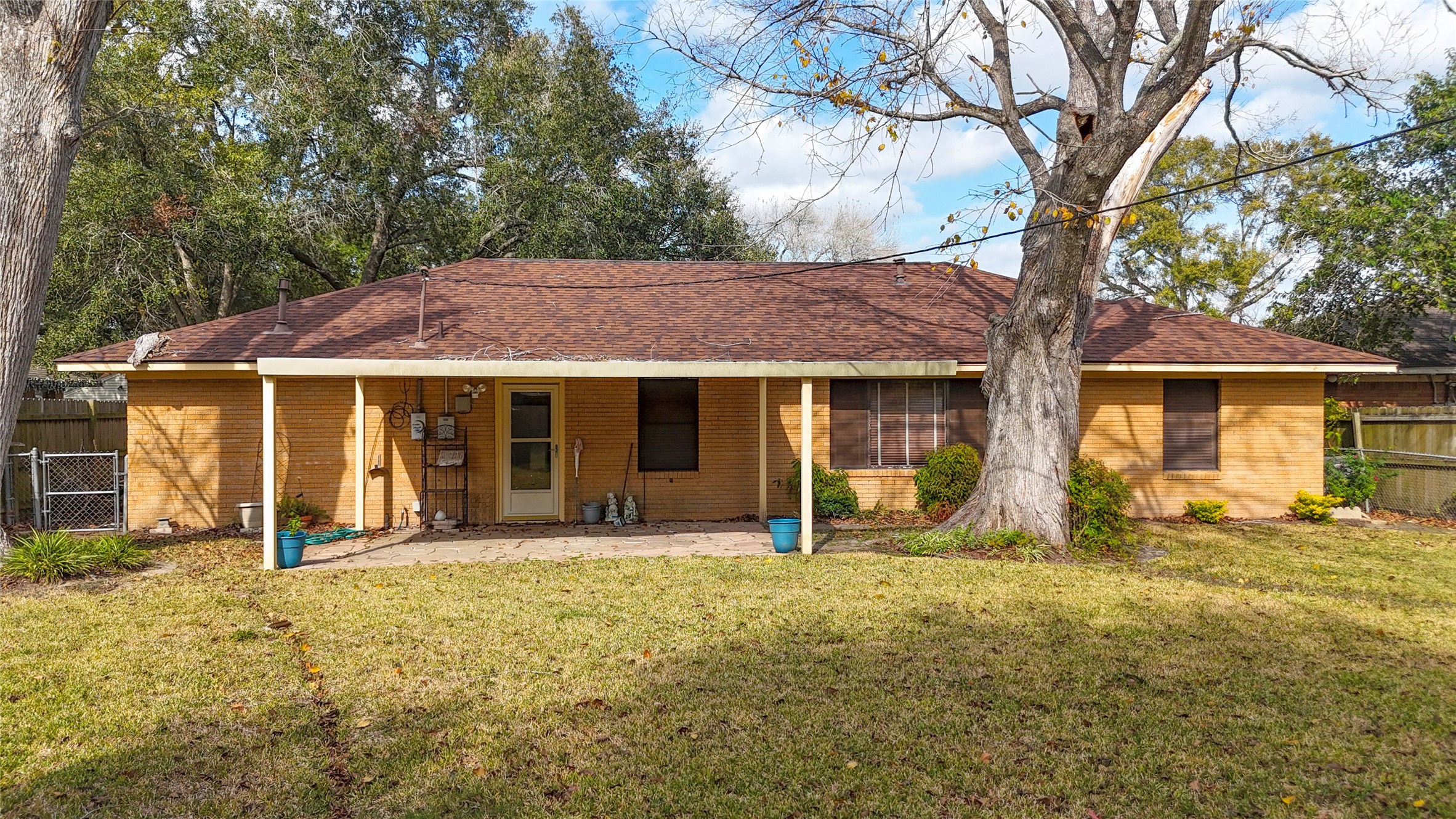 907 Peach Street El Campo, TX 77437 - Photo 22 of 25 a front view of a house with yard outdoor seating and barbeque oven