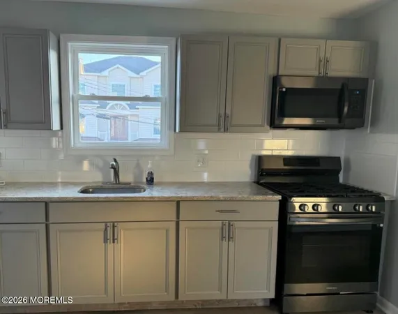 a kitchen with stainless steel appliances granite countertop a stove a microwave and oven
