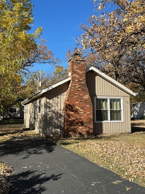 a front view of a house with a tree