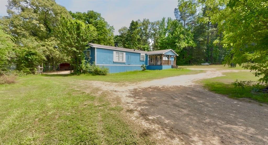 8261 County Road 381 Tyler, TX 75708 - Photo 4 of 40 a front view of a house with a yard and trees