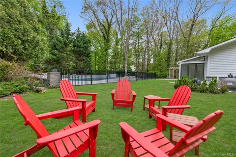 a view of deck with chairs and backyard