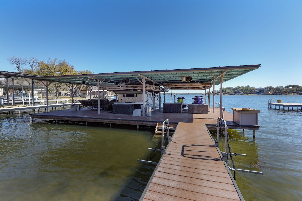 Large private boat dock with sitting area and 2 lifts with electric shields for large boat and 2 jet skis.