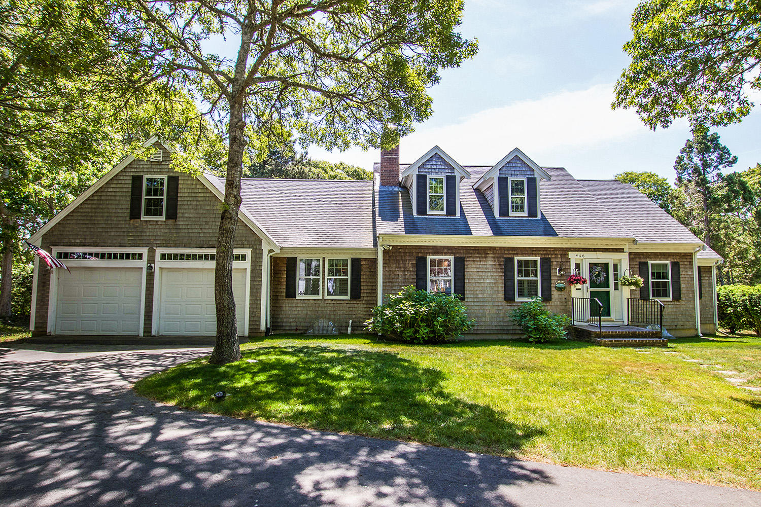 a front view of a house with garden