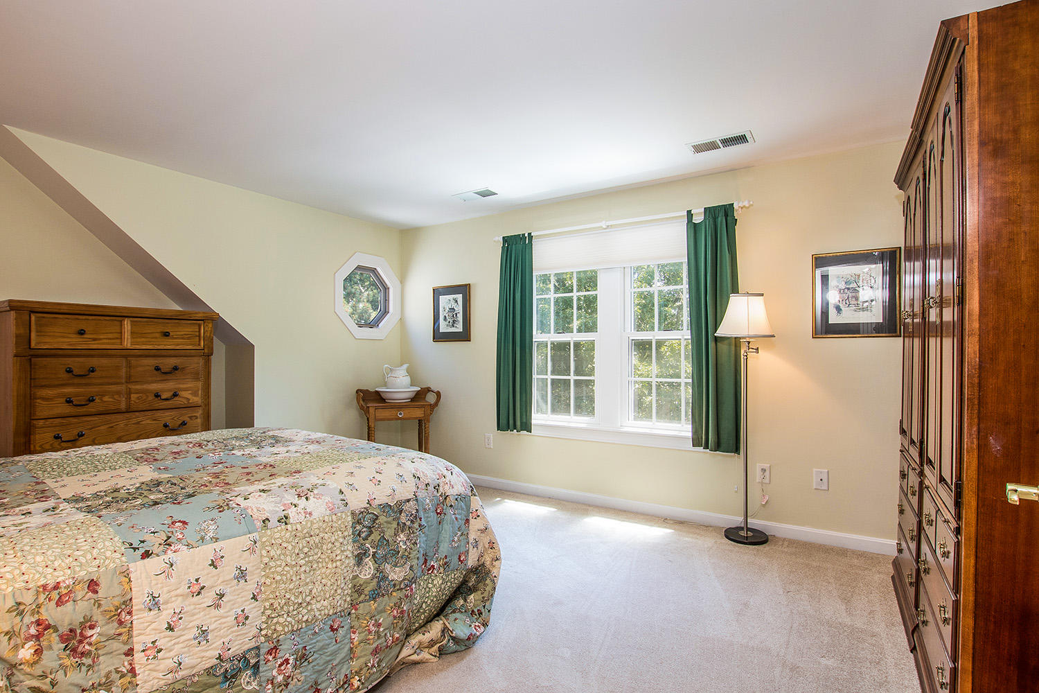 466 Training Field Road Chatham, MA 02633 - Photo 17 of 25 a bedroom with a bed and a dresser next to a window