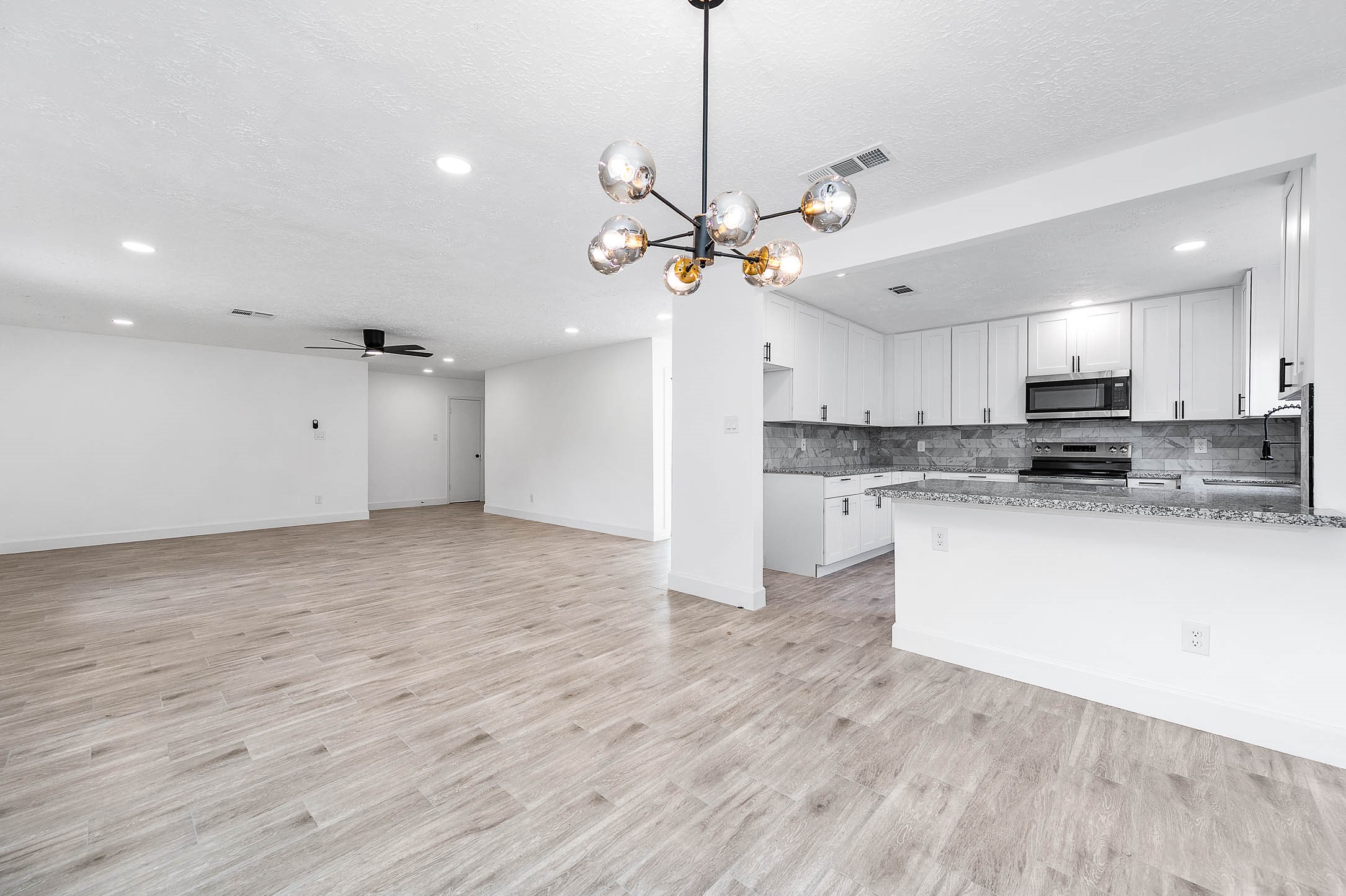 a view of a kitchen with marble kitchen and stainless steel appliances